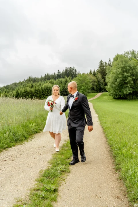 Georg zieht seine Braut Daniela den Waldweg entlang - Martin Schinnerl Fotografie